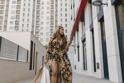 Woman standing outside building