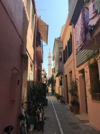 Street amidst buildings against sky in city