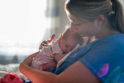 Midsection of mother and daughter holding hands