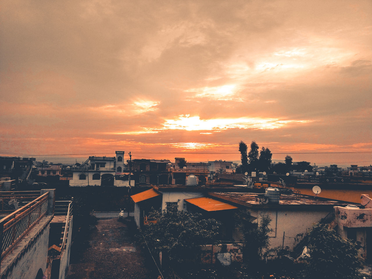 sky, sunset, cloud - sky, architecture, building exterior, built structure, city, cityscape, high angle view, orange color, nature, building, no people, residential district, outdoors, water, sunlight