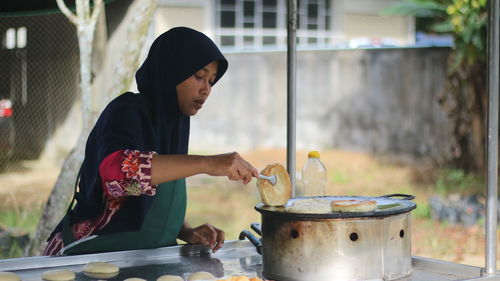 Midsection of man preparing food