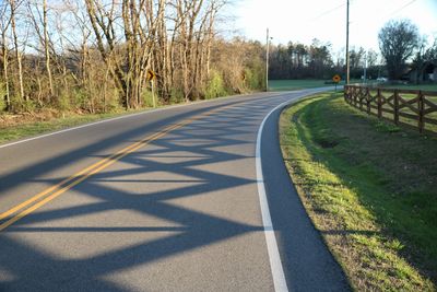 Road amidst trees against sky