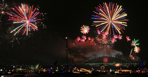 Low angle view of firework display at night