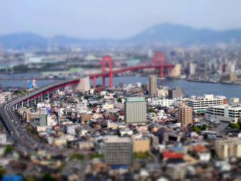 Tilt-shift image of cityscape against sky