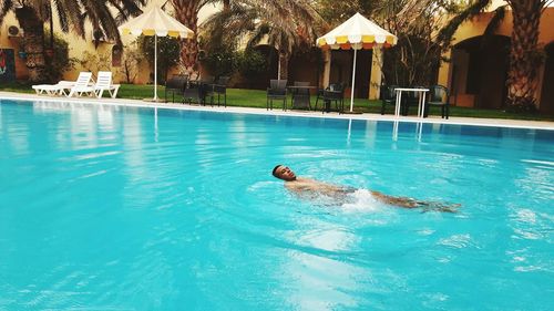 Man swimming in pool