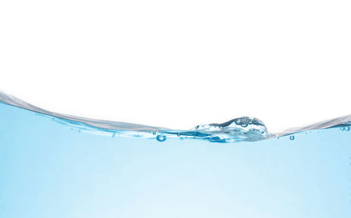 Close-up of water splashing against white background
