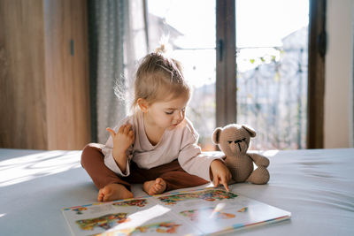 Side view of girl playing with toy on table