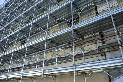 Extensive scaffolding that provides platforms for work in progress on an old building