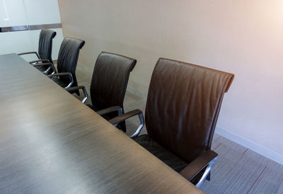 Empty chairs in conference room at office