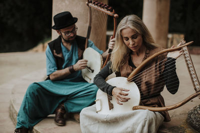 Young man with woman sitting outdoors