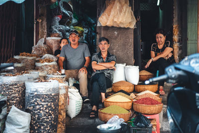 People sitting at market stall