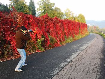 Woman photographing on road