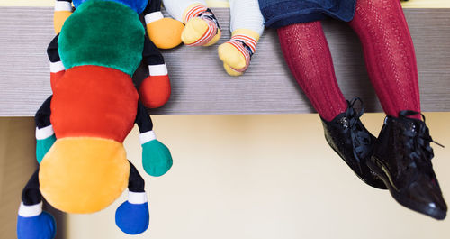 Low section of boy wearing multi colored pencils