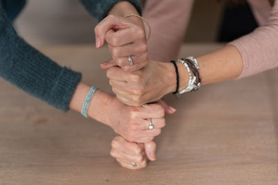 Midsection of couple hands on table