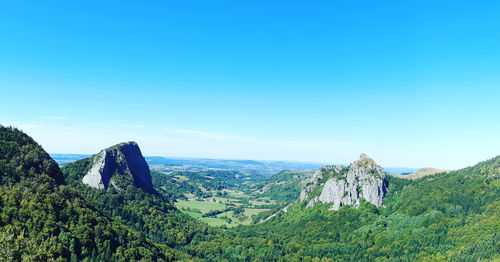 Scenic view of mountains against clear blue sky