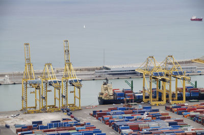 Commercial dock with cargo container and cranes by sea against sky, barcelona 