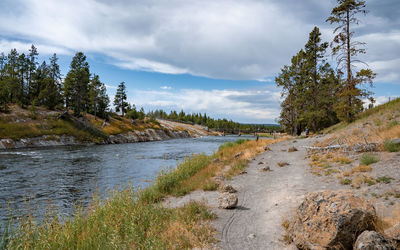 Pathway by beautiful firehole river in midway geyser at yellowstone park