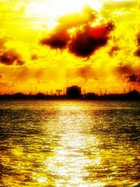 Scenic view of sea against cloudy sky during sunset