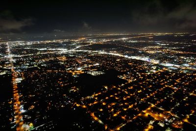 High angle view of illuminated buildings in city at night