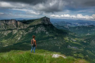 Man standing on mountain against sky