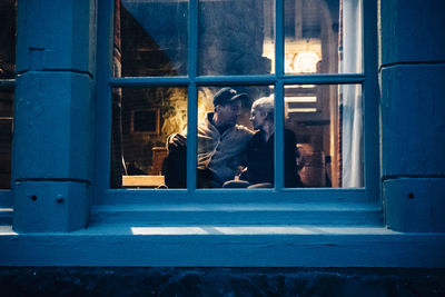 Man seen through glass window