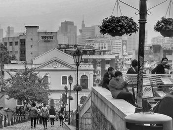 Group of people in front of buildings in city