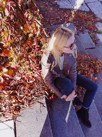 High angle view of woman with autumn leaves