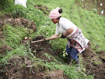 Rear view of woman working at farm