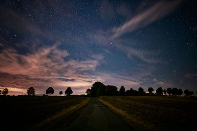 Scenic view of field against sky at night