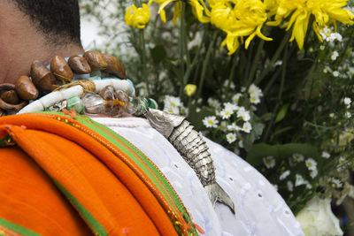 Close-up of man holding flowering plant