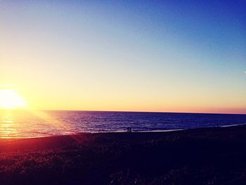 Scenic view of sea against clear sky during sunset