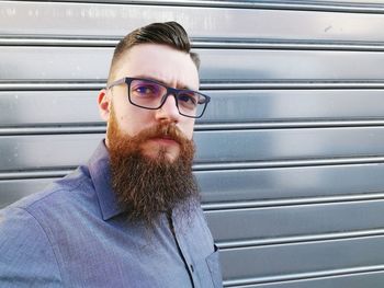 Portrait of bearded man against shutter