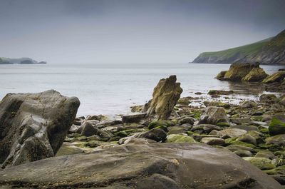 Rocks on beach against sky