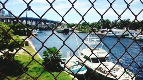 Full frame of chainlink fence over view of river