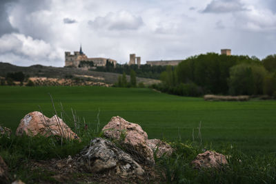 Landscape in ucles with the monastery and the castle in the background against sky, cuenca, spain