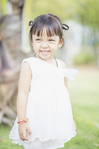 Portrait of cute girl standing on field