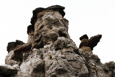 Low angle view of rock formation against clear sky