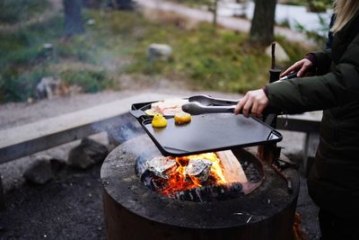 Man preparing food on barbecue grill