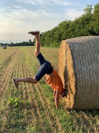 Rear view of man standing on hay