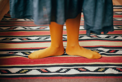 Low section of women standing on carpet