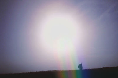 Scenic view of rainbow over landscape against sky