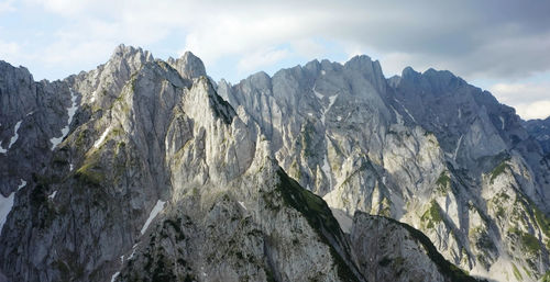 Scenic view of mountains against cloudy sky