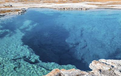 Close-up of sapphire pool with sky in background at yellowstone national park