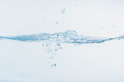 Close-up of bubbles over sea against white background