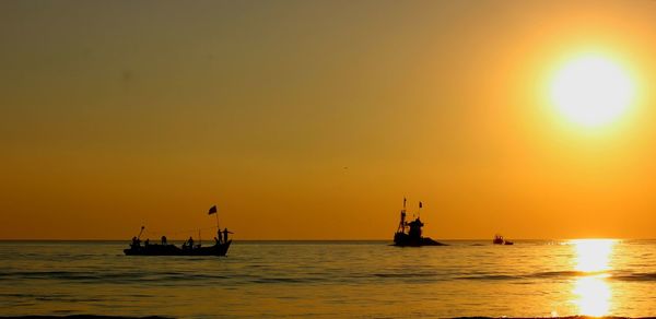 Scenic view of sea against orange sky