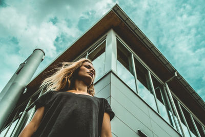 Low angle view of woman against sky