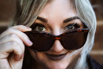 Close-up portrait of young woman wearing sunglasses