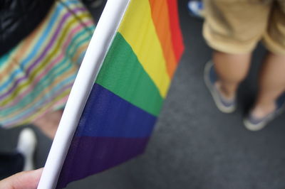 Close-up of person holding rainbow flag