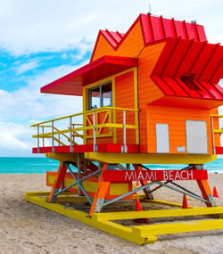 Lifeguard hut on beach against sky