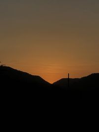 Scenic view of silhouette landscape against clear sky during sunset